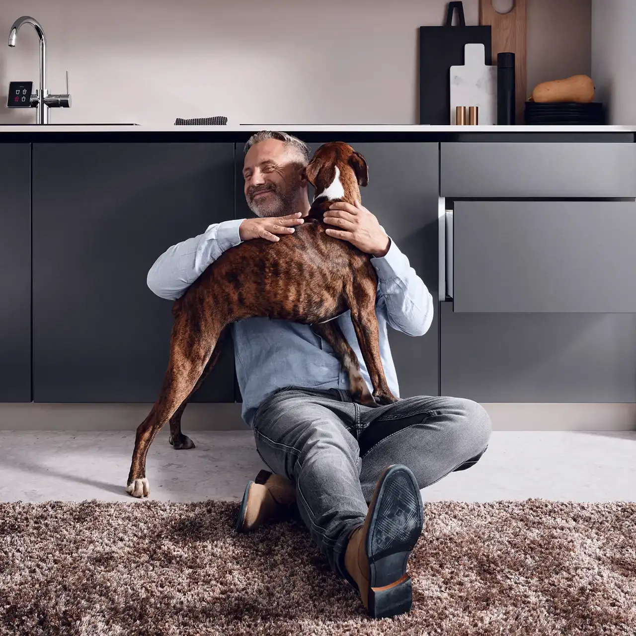 Models wanted - Ein Mann nimmt einen Hund in den Arm